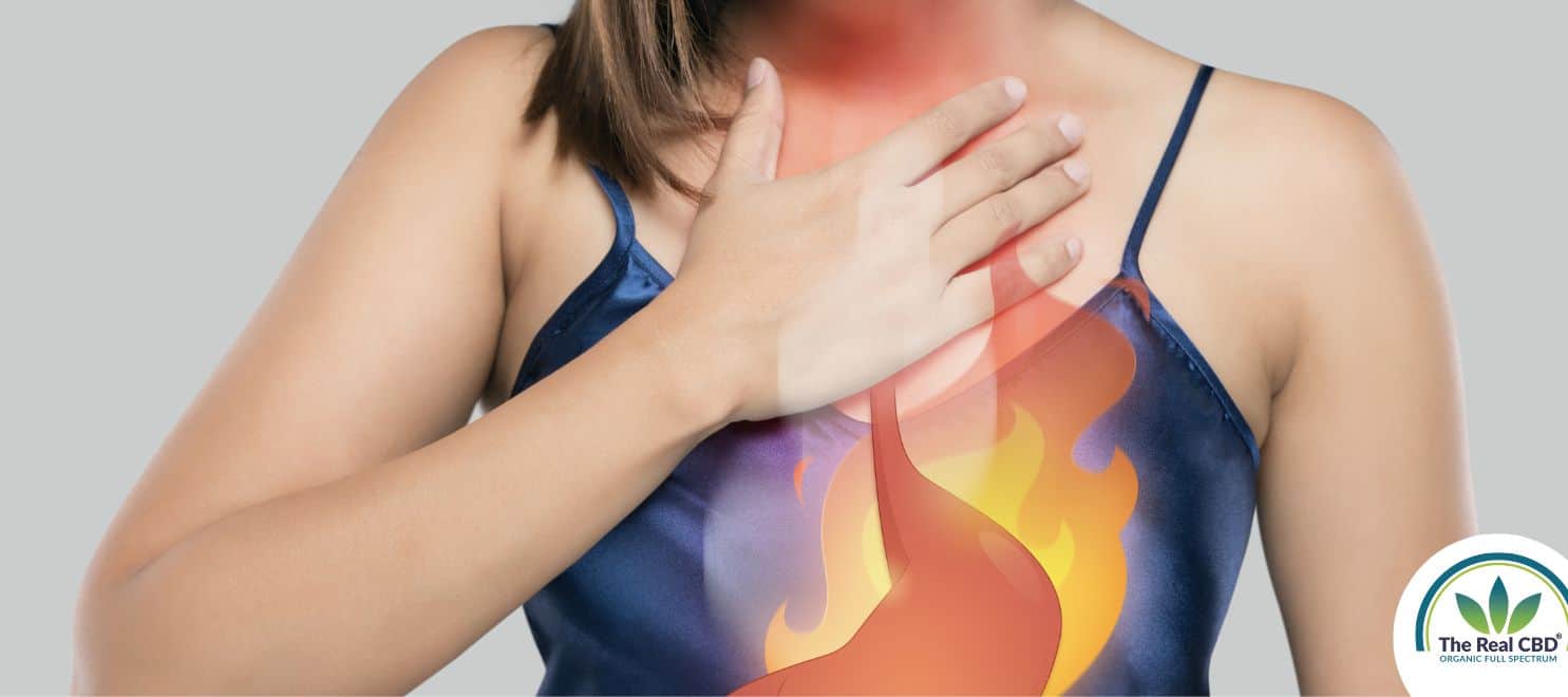 Woman holding her chest in pain showing heartburn