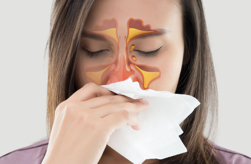 Woman blowing her nose having blocked sinuses
