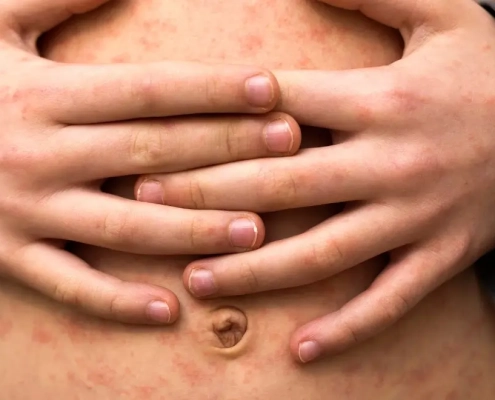 Person holding their stomach in pain