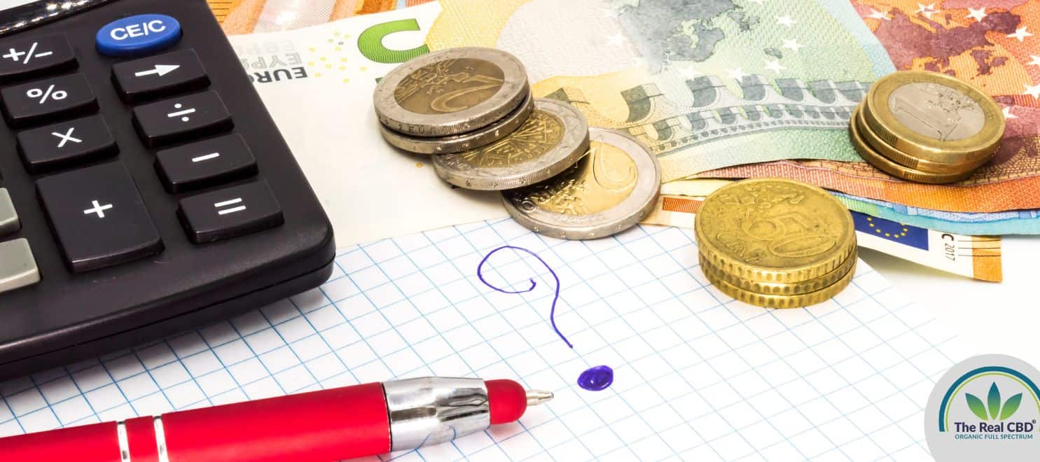 Calculator, money and a pen on top of a map