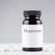 A tub of magnesium and a bottle of CBD oil