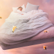 Woman sleeping in a big bed flying in the sky