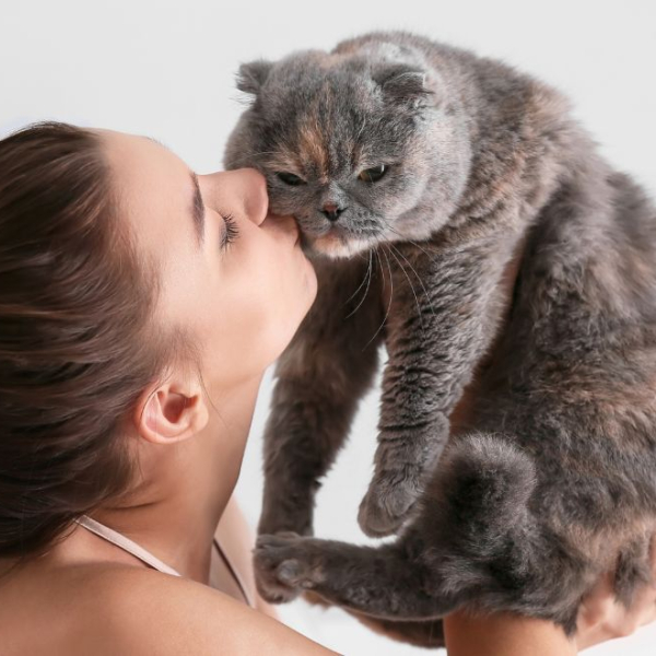 Woman kissing her cat