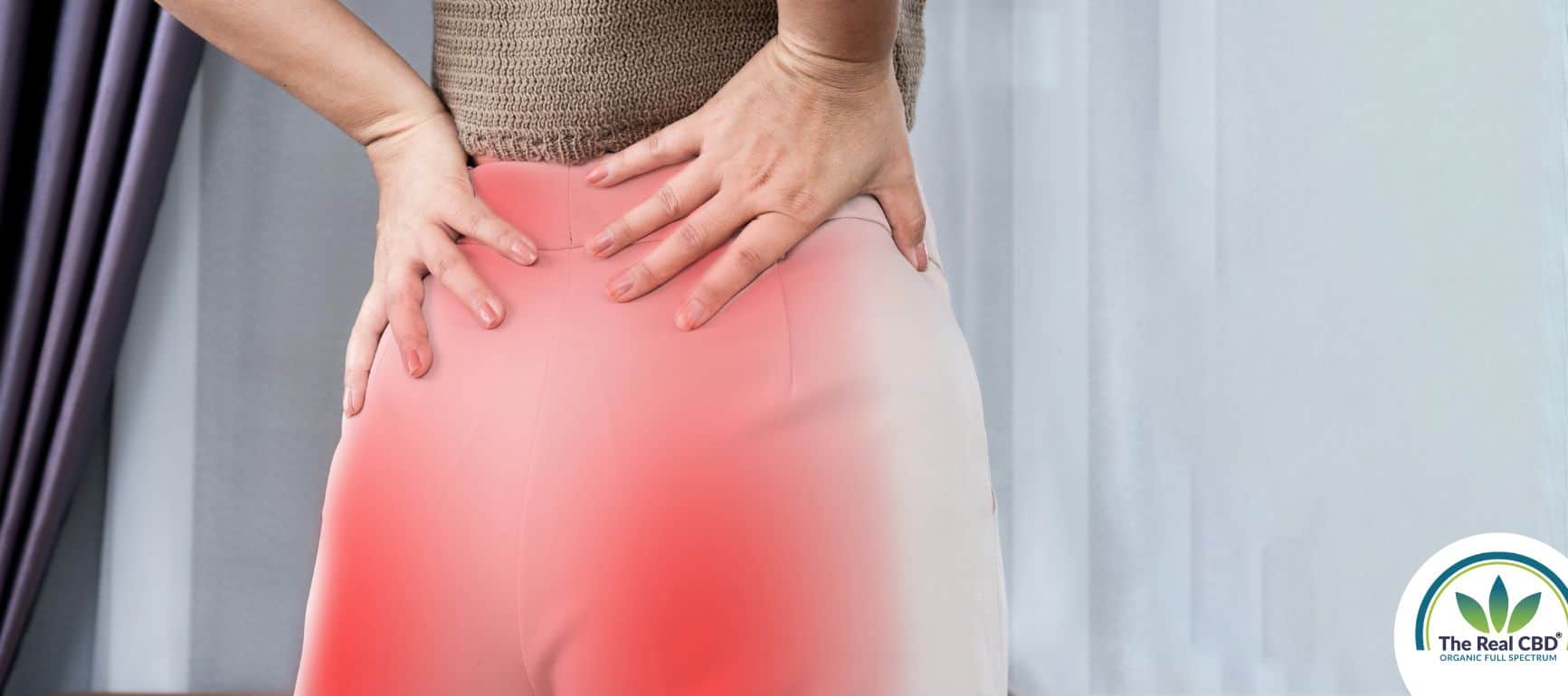 Woman with sciatica pain holding her back