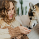 Woman trying to give a treat to a picky dog