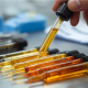 Various pipettes with different coloured oil inside