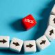White dice with plack arrows going upwards with a red STRESS dice in the middle