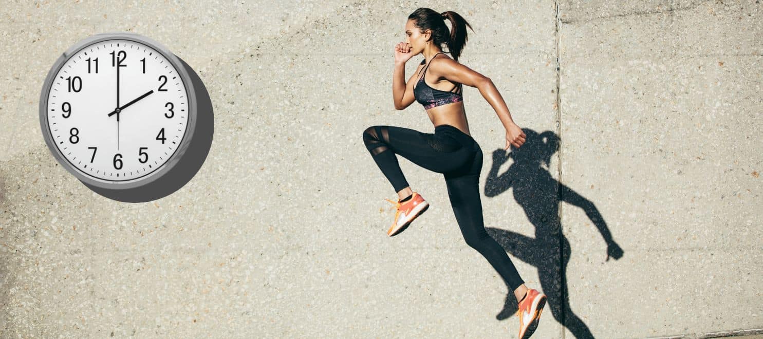 Woman and her shadow jumping infront of a wall clock