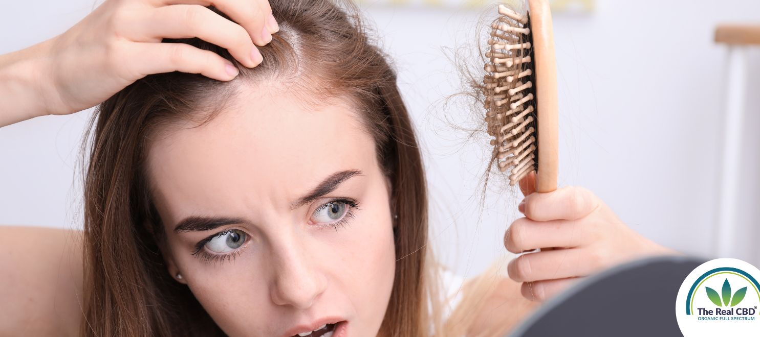 Woman looking frightned on her hairbrush full og hair