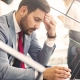 Man sitting on a starircase looking exhausted