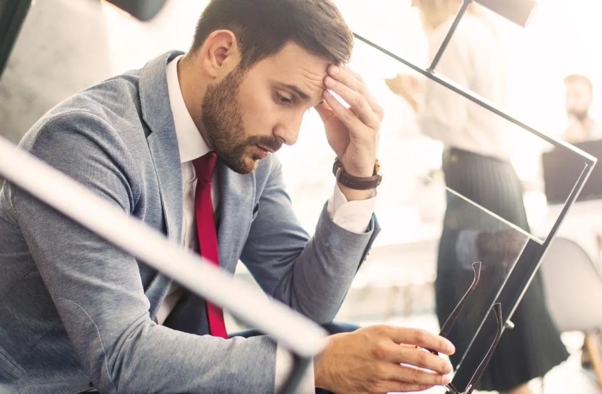 Man sitting on a starircase looking exhausted