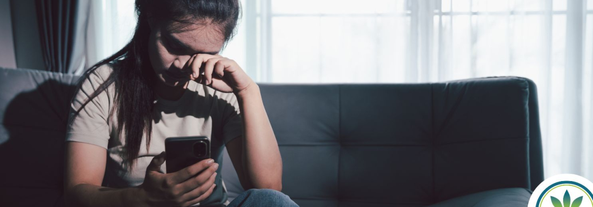 Woman sitting on a sofa looking overwhelmed