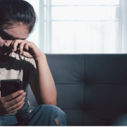 the-real-cbd-blog-CBD-for-mental-overwhelm Woman sitting on a sofa looking overwhelmed