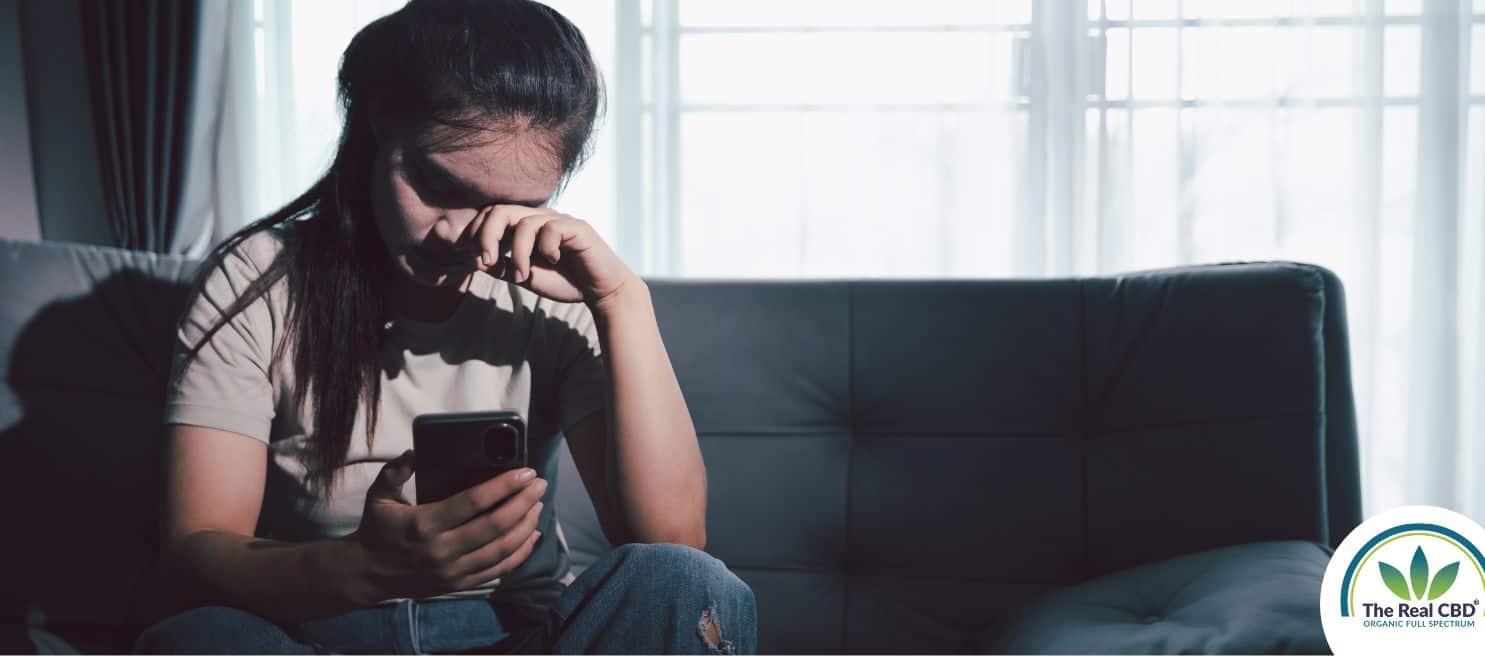 Woman sitting on a sofa looking overwhelmed