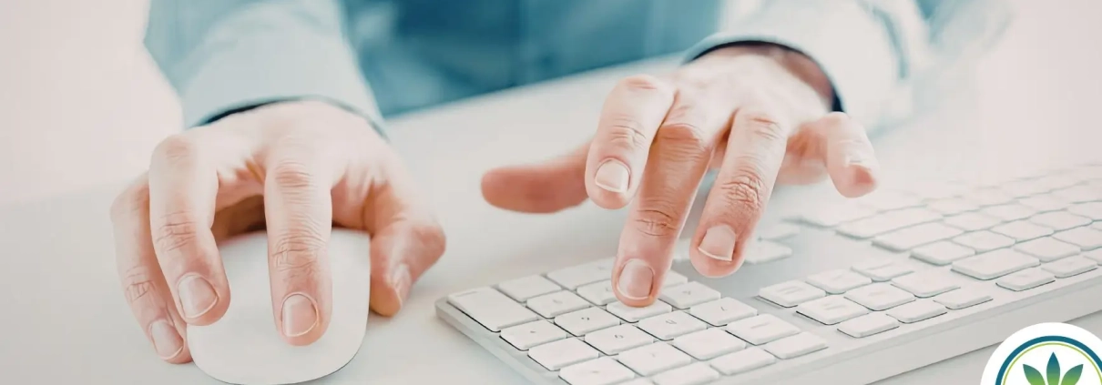 A set of hands working on a keyboard and a mouse