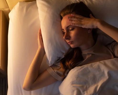 Woman laying in bed trying to sleep