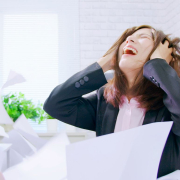 the-real-cbd-blog-CBD-for-Irritability-Linked-to-Chronic-Stress Woman looking distraught sitting by her desk