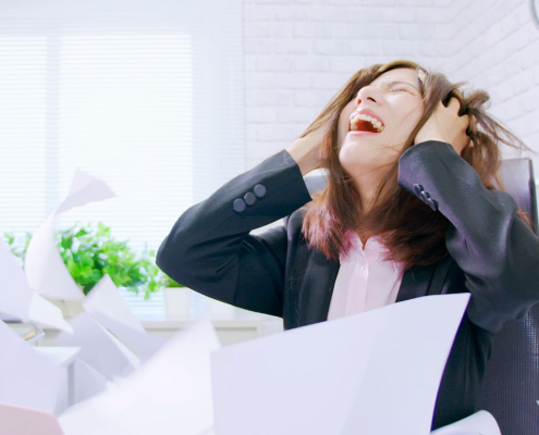 Woman looking distraught sitting by her desk
