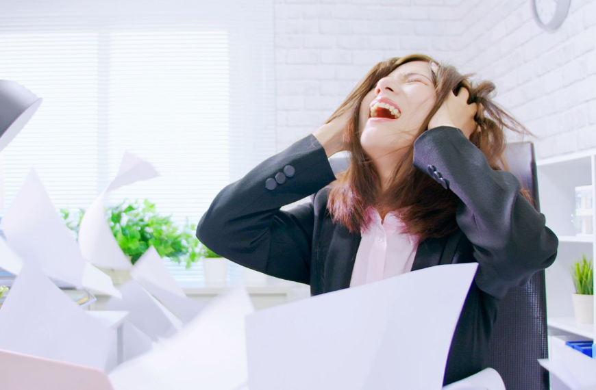 Woman looking distraught sitting by her desk