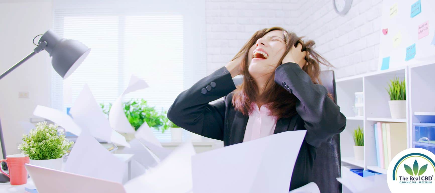 Woman looking distraught sitting by her desk