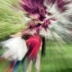 Blurry tunnel vision of two people walking in the forrest